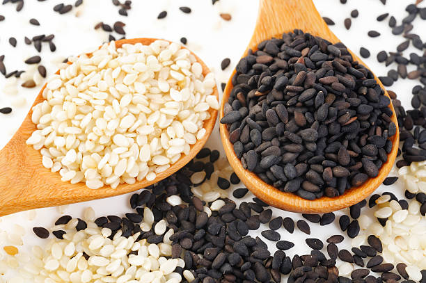 white sesame and black sesame on wood spoon